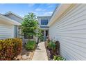 Landscaped side yard with walkway leading to entrance at 122 Baytree Blvd, Tavares, FL 32778