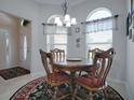 Cozy breakfast nook with round wooden table and four chairs at 1751 Ashwood Run, The Villages, FL 32162