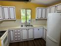 Bright kitchen with white cabinets and dark countertops at 1833 Holly Ln, Lady Lake, FL 32159