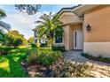 Inviting front entry with walkway and lush landscaping at 33 Camino Real # 303, Howey In The Hills, FL 34737
