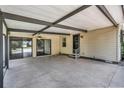 Covered carport with concrete flooring and access to the house at 1551 Hillcrest Dr, Lady Lake, FL 32159