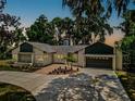 Updated ranch home with a dark garage door and landscaped yard at 1261 W Lakeshore Dr, Clermont, FL 34711