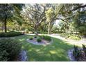 Landscaped yard with mature trees and lush greenery at 3554 County Road 216, Oxford, FL 34484