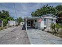 Mobile home exterior with covered porch and American flag at 1306 Westland Dr, Tavares, FL 32778