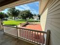 Private backyard patio with seating area and view of neighborhood at 12046 Ne 51St Cir, Oxford, FL 34484