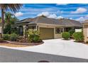 Single-story home with landscaped yard and two-car garage at 658 Arruda Ter, The Villages, FL 32162