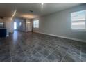 Spacious living room with tile floors and plenty of natural light at 2003 Sunshine Peak Dr, Minneola, FL 34715