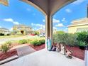 Front porch view with religious statues and landscaped yard at 172 Seville Dr, Davenport, FL 33837