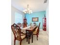 Elegant dining room featuring a large wood table, chandelier, and built-in hutch at 172 Seville Dr, Davenport, FL 33837