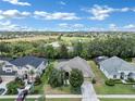 Aerial view of a house in a residential neighborhood at 13144 Coldwater Loop, Clermont, FL 34711