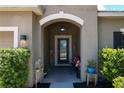 Front entry with arched doorway and seating at 316 Blue Cypress Dr, Groveland, FL 34736