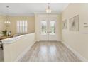 Light and airy entryway with white double doors and hardwood floors at 6514 Crews Lake Crest Loop, Lakeland, FL 33813