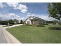 Single story home with brick accents and a nicely landscaped lawn at 6514 Crews Lake Crest Loop, Lakeland, FL 33813