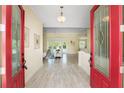 Bright entryway with red double doors and hardwood floors at 6514 Crews Lake Crest Loop, Lakeland, FL 33813