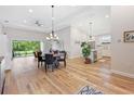 Open dining room with hardwood floors and a chandelier at 5008 Ne 125Th Loop, Oxford, FL 34484