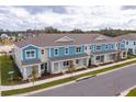 Row of townhouses with blue and gray siding at 13249 Peaceful Melody Dr, Winter Garden, FL 34787