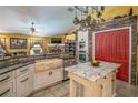 Spacious kitchen with island, farmhouse sink, and stainless steel appliances at 3011 Indian Trl, Eustis, FL 32726