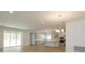 Open concept kitchen with island, stainless steel appliances, and tile flooring at 2368 Juniper Berry Dr, Minneola, FL 34715