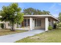 Ranch home with carport and nicely landscaped yard at 1113 Oakland Cir, Tavares, FL 32778