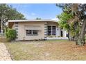 Mid-century home with updated landscaping and stone accents at 1113 Oakland Cir, Tavares, FL 32778