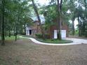 Brick home with attached garage and curved walkway at 415 Se 123Rd Street Rd, Ocala, FL 34480