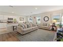 Open living room with neutral furniture and kitchen view at 1163 Haines Dr, Winter Haven, FL 33881