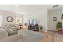 Living room featuring neutral-toned couches and rug at 1163 Haines Dr, Winter Haven, FL 33881