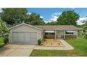 Charming single-story home with a brick facade and attached garage at 17548 Se 96Th Ave, Summerfield, FL 34491