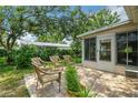 Relaxing patio area with wicker furniture, perfect for outdoor enjoyment at 17548 Se 96Th Ave, Summerfield, FL 34491