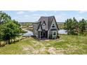 House with a lake view, showcasing a beautiful landscape at 13910 Max Hooks Rd, Clermont, FL 34711
