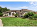 Beautiful one-story home with a lush lawn and mature landscaping at 8692 Crested Eagle Pl, Sanford, FL 32771