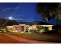 Single Gathering home beautifully lit at night at 8692 Crested Eagle Pl, Sanford, FL 32771