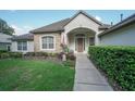 House exterior with stone accents and manicured lawn at 32313 Oak Canopy Dr, Sorrento, FL 32776