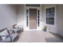Inviting front porch with seating area and decorative rug at 32313 Oak Canopy Dr, Sorrento, FL 32776
