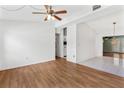 Spacious living room featuring hardwood floors and ceiling fan at 6919 Fern Cir, Leesburg, FL 34748