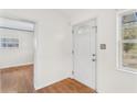 Bright entryway with hardwood floors and white door at 6919 Fern Cir, Leesburg, FL 34748