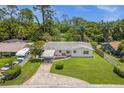 Single story house exterior with green lawn and driveway at 37102 Oak Ln, Umatilla, FL 32784