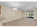 Bright dining room with sliding glass doors leading to a patio at 3603 Solana Cir # B, Clermont, FL 34711