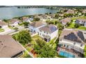 Aerial view of house and neighborhood near lake at 1103 White Water Bay Dr, Groveland, FL 34736