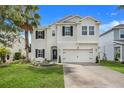 Two-story house with a white exterior and landscaped yard at 1103 White Water Bay Dr, Groveland, FL 34736