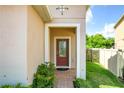 Inviting front entrance with a red door and brick walkway at 17106 Gathering Place Cir, Clermont, FL 34711