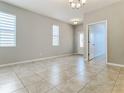 Spacious living room with tile floors and access to other rooms at 17106 Gathering Place Cir, Clermont, FL 34711