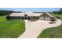 Aerial view of a single-Gathering home with a large yard and attached garage at 2499 Nw 102Nd Blvd, Wildwood, FL 34785