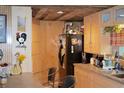 Rustic kitchen with wood cabinets and a black refrigerator at 16640 Ne 148Th Terrace Rd, Fort Mc Coy, FL 32134