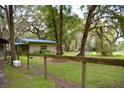 Home with a fenced backyard and mature trees at 16640 Ne 148Th Terrace Rd, Fort Mc Coy, FL 32134