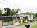 Two story house with gated entry and solar panels at 1304 Ocoee Apopka Rd, Ocoee, FL 34761