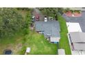Aerial view of a home with a large backyard and outbuildings at 1817 Demastus Ln, Ocoee, FL 34761