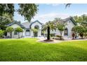 One-story home with manicured lawn and palm tree at 19425 Spring Oak Dr, Eustis, FL 32736