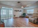 Living room with laminate floors, couches, and a view of a sunroom at 853 Cr 484, Lake Panasoffkee, FL 33538