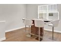Breakfast bar with four white leather barstools at 137 S Park Ave, Winter Garden, FL 34787